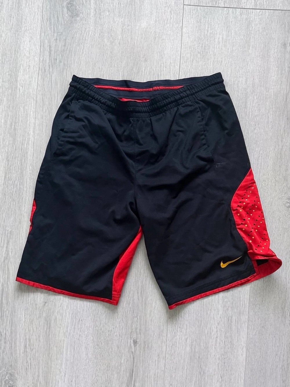 Nike Men’s Black Shorts with Red Panels and Yellow Swoosh